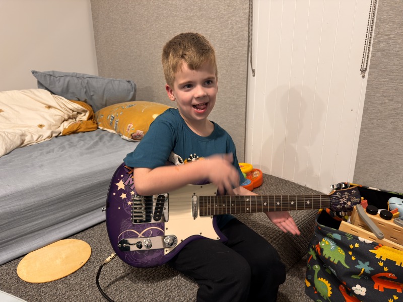 Casper playing his new guitar on his 6th birthday